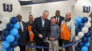 Ryan Pivoney/News Tribune
LU President John Moseley cuts the ribbon to Lincoln's new student innovation lounge during a ceremony Thursday in Schweich Hall. He is surrounded by members of the LU Board of Curators, the project contractor and representatives from The Home Depot in Columbia.